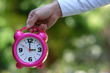 Wall Mural - man holding alarm clock