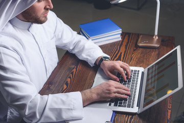 Poster - Arab businessman working in office late at night