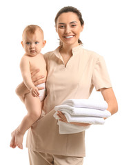 Poster - Massage therapist with cute baby on white background