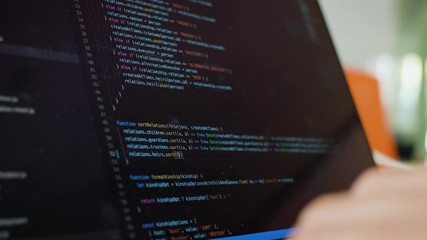 writing code on laptop. software developer writes code from home. remote work and freelance concept.
