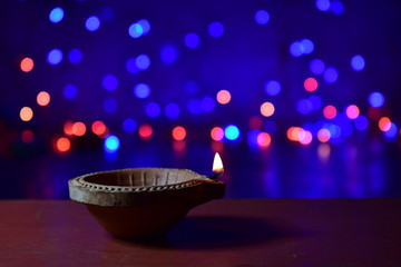 Wall Mural - Diya lamps lit with bokeh background during diwali celebration