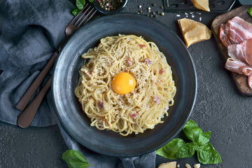 Wall Mural - spaghetti Carbonara with yolk and bacon on a dark background