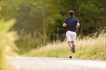 Detail of man running free in nature. Ideal to express the concept of vitality and healthy life. Copy space.