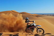 Riding Motorbike In The Desert Dunes.
