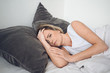© Алина Троева - Depressed woman tormented by restless sleep, she is exhausted and suffering from insomnia, bad dreams or nightmares, psychological problems. Inconvenient uncomfortable bed or mattress. Lack of sleep