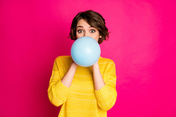 Portrait of cute funny lovely youth girl have festive occasion prepare party blow inflate balloon wear vivid jumper isolated over shine color background