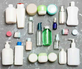 Group of plastic bodycare bottle Flat lay composition with cosmetic products on green background empty space for you design. Set of White Cosmetic containers, top view with copy space