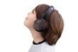 Happy child listening to music looking up with headphones, profile portrait. Isolated on a white background.