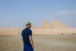 man against the background of Egyptian pyramids