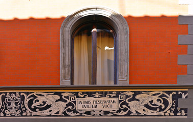 Sticker - Detail of facade with window and decorations in the medieval village of Sansepolcro near city of Arezzo with house former temple of Freemasonry in Tuscany, Italy