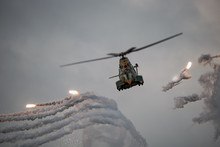 Military Combat Helicopter Firing Flares At Dusk, Thermal Protection For Missile Attack.