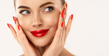beautiful girl showing red manicure nails & lips. woman makeup, beauty and cosmetics