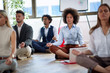 © luckybusiness - Office employees taking a break to do a meditation. Coworkers meditating on the floor.