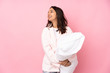 © luismolinero - Young woman in pajamas isolated on pink background happy and smiling