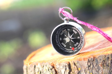 old compass on natural wooden background