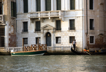 Wall Mural - Photo of Grand canal in Venice with historical facades made in baroque and renaissance styles with balustrades,  piles, gondola in sunny summer day.