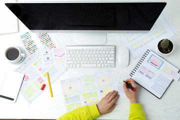 Wall Mural - the designer develops websites by sketching the application interface.