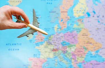 Toy plane and Europe map on the background.