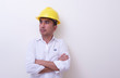 © rufous - engineer with hands crossed wearing yellow helmet on white background