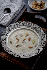 Wall Mural - Kheer or Payasam is a type of rice pudding from the Indian subcontinent, made by boiling milk and sugar and is flavoured with dry fruits and nuts, served in decorative plate.