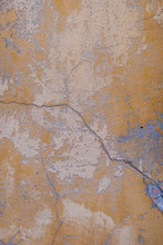 Old Vintage Cracked Concrete Wall Painted In Yellow Shabby Paint With Hints Of White And Gray Colors Industrial Vertical Layout Close Up Of The Texture For Mobile Users Copy Space Pale Colors