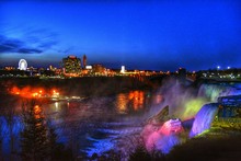Illuminated Colorful Niagara Falls Against Sky At Night