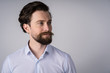 © Ivan - Portrait of young man with beard in white shirt, he smiles and looks away