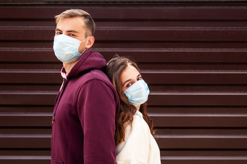 Young man and woman in face protective masks. Covid-19 pandemic