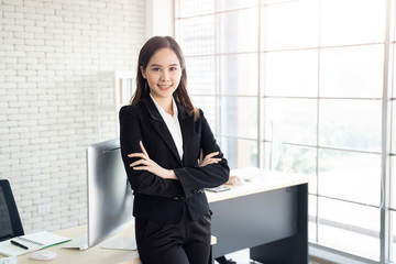 Wall Mural - multiethnic asian female ceo or executive working in office to standing smiling with confident in planning strategy, work concept of diversity of culture different race type people co-working together