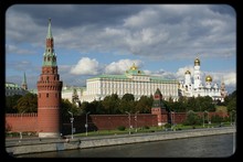 Canal In Front Of Beklemishevskaya Tower And Grand Kremlin Palace Against Cloudy Sky