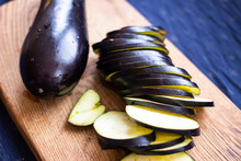Chopped, Cut Eggplants Or Aubergine Slices On Board.