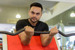 © Ranta Images - Young bearded Indian man lifting weights at the gym