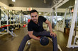 © Ranta Images - Full body shot of young bearded Indian man lifting weights at the gym