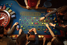 Top view of people playing roulette at the table in a casino