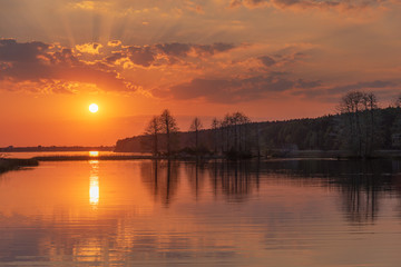 Wall Mural - charming landscape on the river at sunset and night time