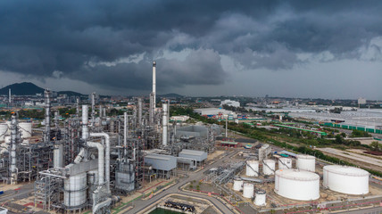 Wall Mural - Aerial view of chemical oil refinery plant, power plant and metal pipe at strom sky background.