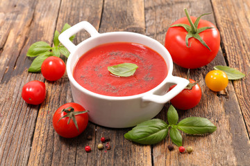 Wall Mural - tomato sauce with basil on wood background