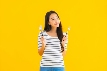 Wall Mural - Portrait beautiful young asian woman show spoon and fork ready to eat