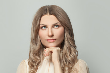 Nice woman with natural skin and healthy hair looking up