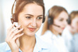 © rogerphoto - Call center. Focus on beautiful business woman in headset
