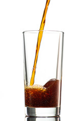 pour a dark drink in the mill on a white background, similar to cola, kvass, tea, dark beer