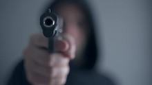Criminal Aiming Gun Camera, Threatening Burglar At Victim