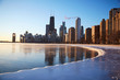 A view from the frozen lakefront of the beautiful downtown chicago skyline on a subzero winter morning sunrise