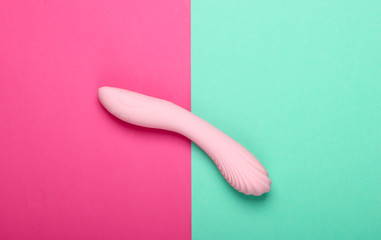 Sex toy for women on pink blue background. Top view, minimalism