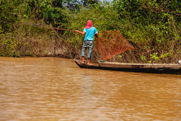 Tonle SAP, Cambodia - February 2014: Kampong Phluk village during drought season. Life and work of residents of Cambodian village on water, near Siem Reap, Cambodia
