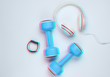 © splitov27 - Dumbbells, smart bracelet, headphones on a white background. Minimalistic sport concept. Top view. Glitch effect