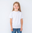 © Ievgen Skrypko - Funny little kid girl wearing a blank white t-shirt, isolated on white background