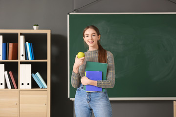 Canvas Print - Pupil with apple in classroom