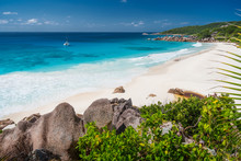 Petite Anse, La Digue In Seychelles - Tropical And Paradise Beach. Yacht Boat At Anchor In Blue Lagoon