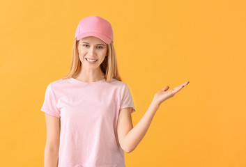 Poster - Beautiful young woman in stylish cap on color background